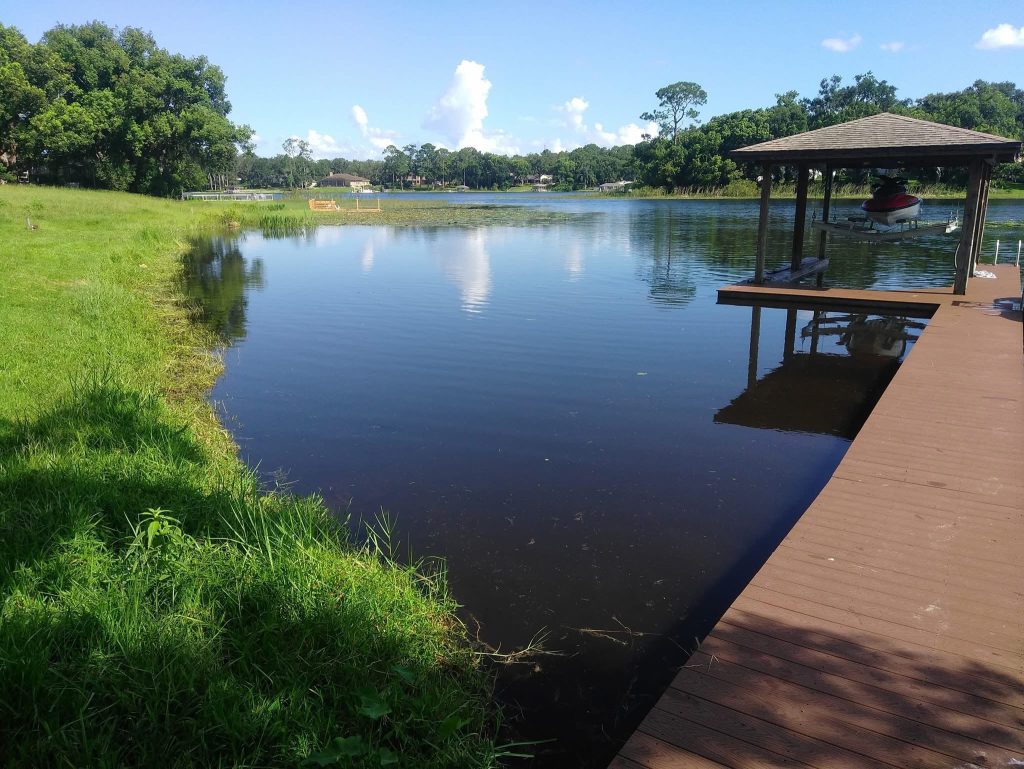 Restored lakefront with dock and clear water